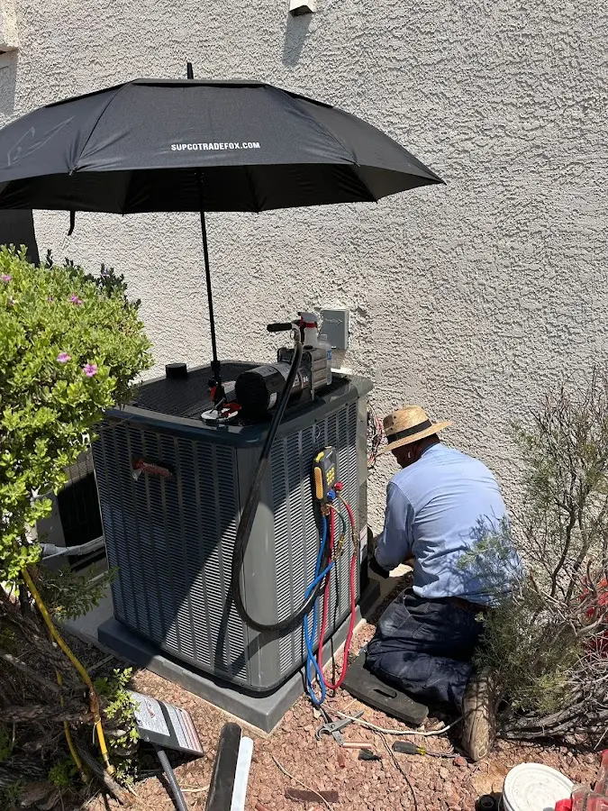 HVAC technician performing outdoor AC maintenance in Lysander